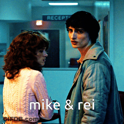 Man And Woman Standing With Mike & Rei GIF