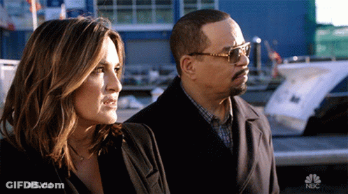 Man And Woman Standing With NBC Logo GIF