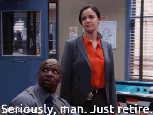 Man And Woman Standing With Seriously Man Just Retire GIF