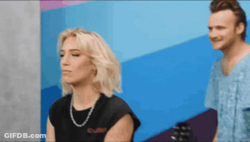 Man And Woman Standing, Woman In Black Shirt Saying Culture GIF