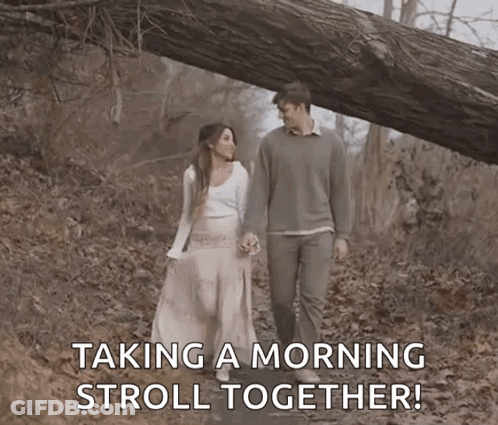 Man And Woman Taking Morning Stroll In Woods GIF