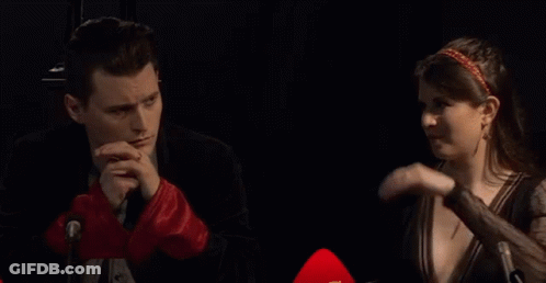 Man And Woman Talking At Microphone GIF
