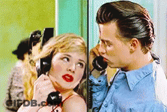 Man And Woman Talking On Telephone GIF