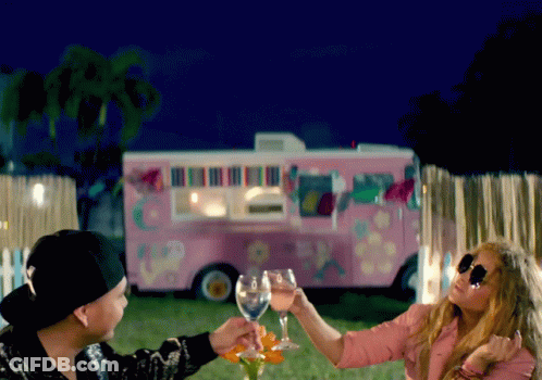Man And Woman Toasting In Front Of Pink Truck GIF