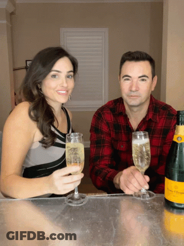 Man And Woman Toasting With Champagne Glasses GIF