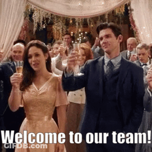 Man And Woman Toasting With Champagne Saying Welcome To Our Team GIF