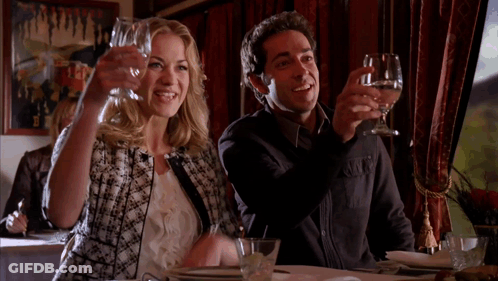 Man And Woman Toasting With Wine Glasses In Restaurant GIF