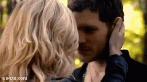 Man And Woman Touching Faces In Forest GIF