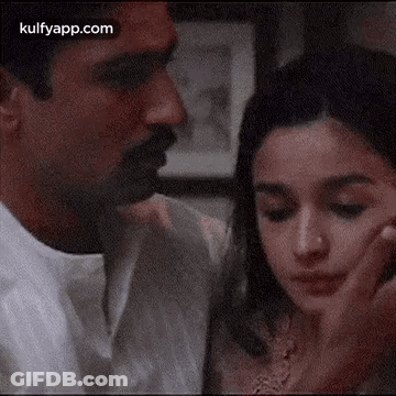 Man And Woman Touching Faces GIF