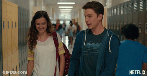 Man And Woman Walking Down Hallway With Netflix GIF