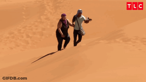 Man And Woman Walking Down Sand Dune Oh My God You're Lazy GIF