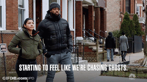 Man And Woman Walking Down Street Chasing Ghosts GIF