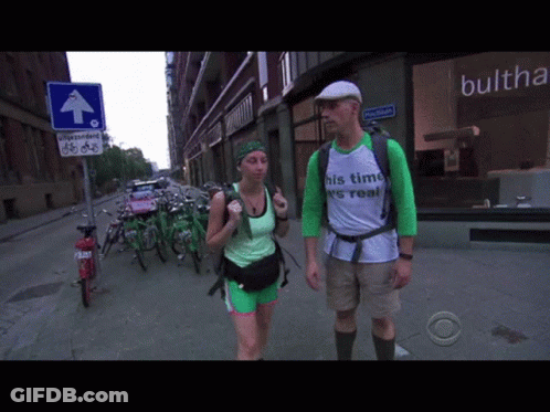 Man And Woman Walking Down Street Shirt Says His Time Is Real GIF