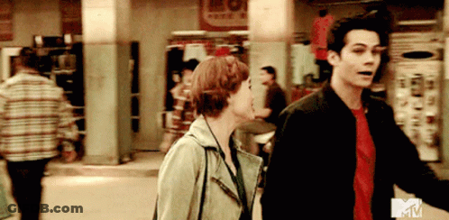 Man And Woman Walking Down Street With MTV Logo GIF