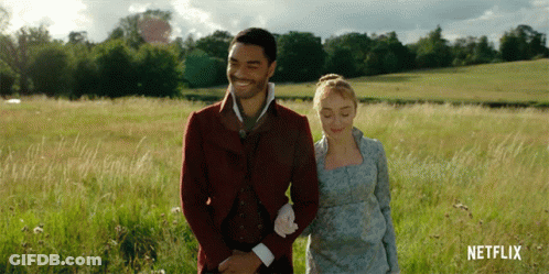 Man And Woman Walking In Field With Netflix Logo GIF