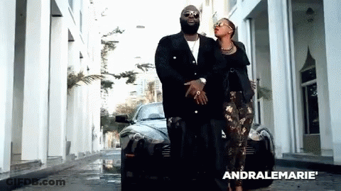 Man And Woman Walking In Front Of Black Car With Word Andralemarie GIF