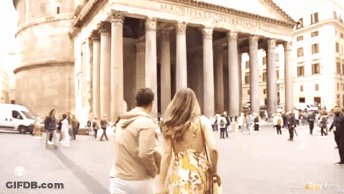Man And Woman Walking In Front Of Magrippale Fort Templar GIF