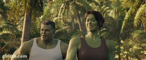 Man And Woman Walking In Lush Green Forest GIF