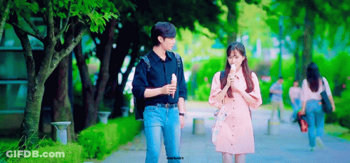 Man And Woman Walking On Sidewalk GIF