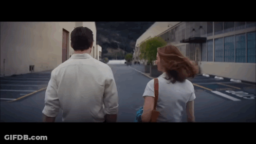 Man And Woman Walking Past No Parking Sign GIF