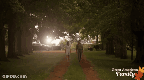 Man And Woman Walking With Great American Family GIF