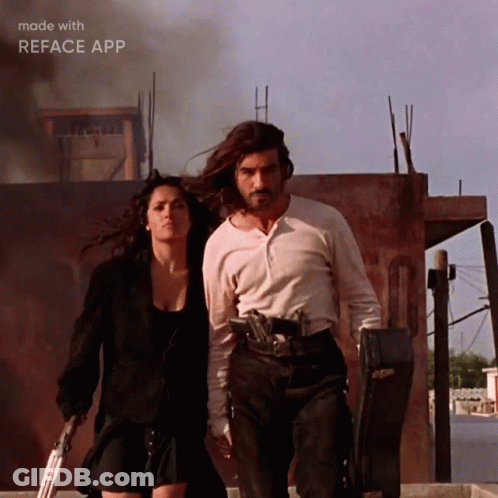 Man And Woman Walking With Guns GIF