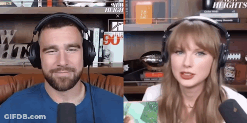 Man And Woman Wearing Headphones Next To New Heights Sign GIF
