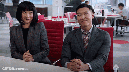 Man And Woman With Folded Hands At Office Table GIF