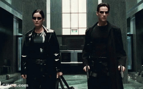 Man And Woman With Guns GIF