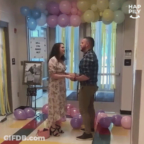 Man And Woman With Marry Me Sign GIF