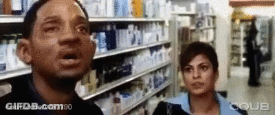Man And Woman With Mouths Open In Store GIF