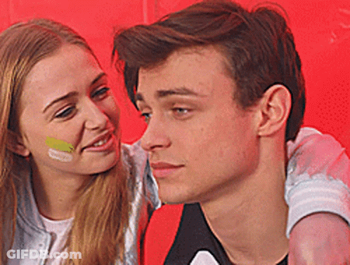 Man And Woman With Painted Faces Looking At Each Other GIF