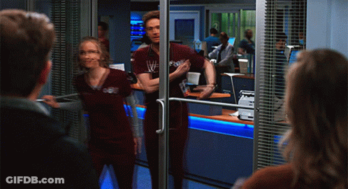 Man And Woman With Stethoscope In Front Of Glass Door GIF