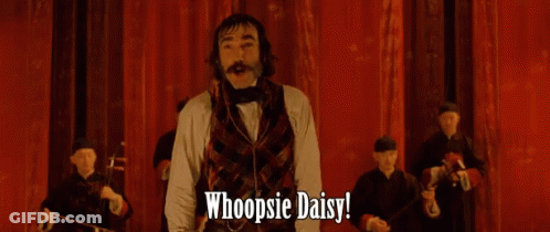 Man Arms Outstretched Saying Whoopsie Daisy Red Curtain GIF