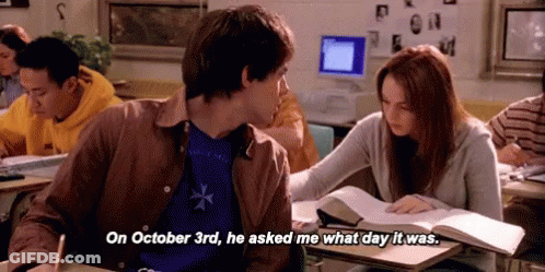 Man Asking Woman What Day It Was At Desk GIF
