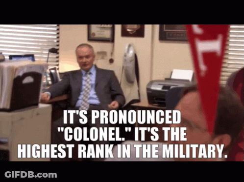Man At Desk Saying It's Pronounced Colonel GIF