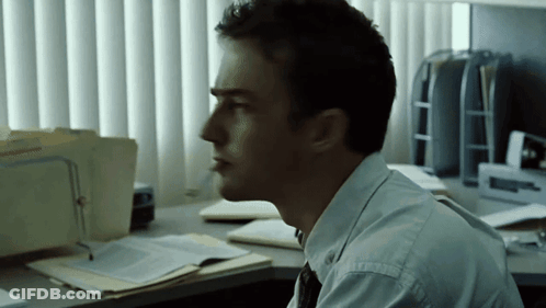 Man At Desk With Attorney Folder By Window GIF