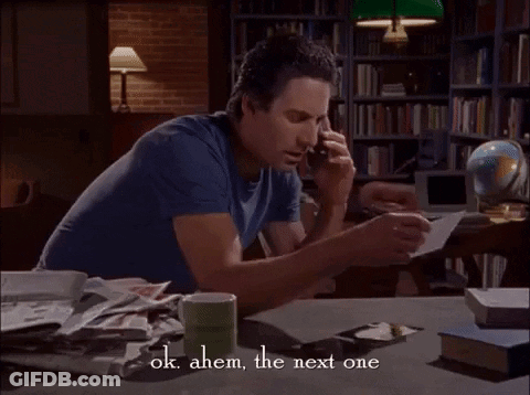 Man At Desk With Books And Coffee Saying Ok Ahem The Next One GIF