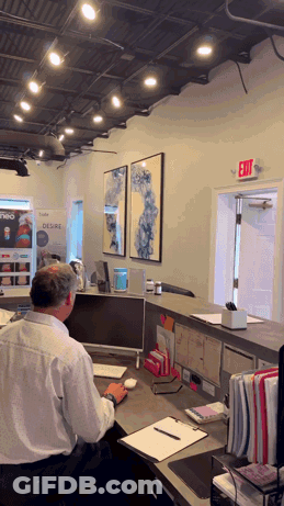 Man At Desk With Exit Sign GIF