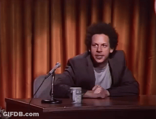 Man At Desk With Hands In Air GIF