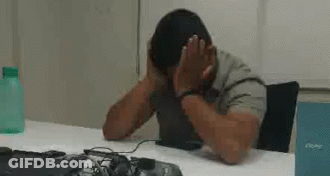 Man At Desk With Hands On Face GIF
