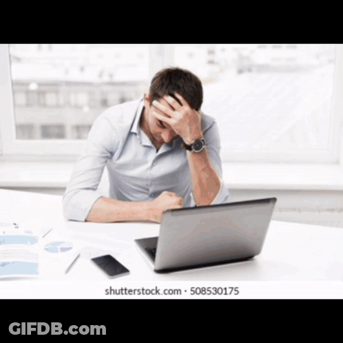 Man At Desk With Hands On Head In Front Of Laptop GIF