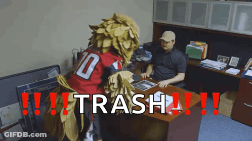 Man At Desk With Mascot Saying Trash GIF