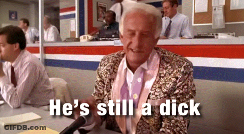 Man At Desk With Mic Saying He's Still A Dick GIF