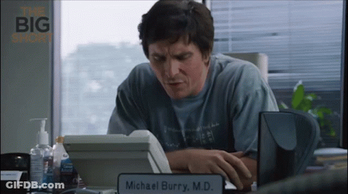 Man At Desk With Michael Burry M.D. Sign GIF