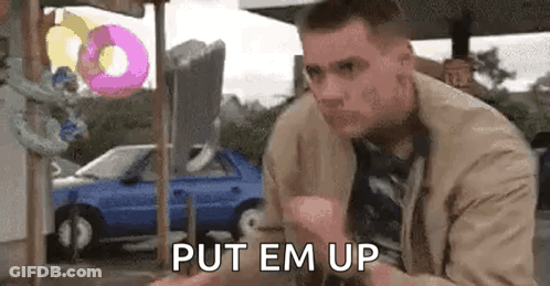 Man At Donut Stand Saying Put Em Up GIF