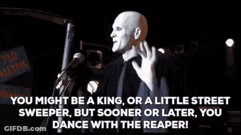 Man At Microphone In Dark Room With Crowd GIF