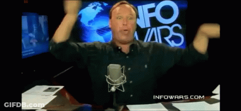 Man At Microphone In Front Of Info Wars Screen GIF