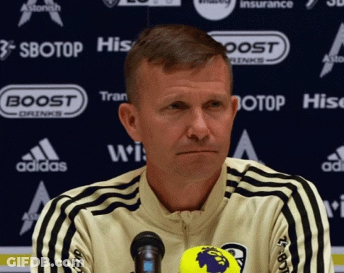 Man At Microphone In Front Of Sbotop Banner GIF