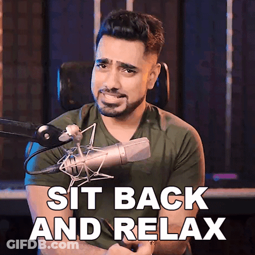Man At Microphone Saying Sit Back And Relax GIF